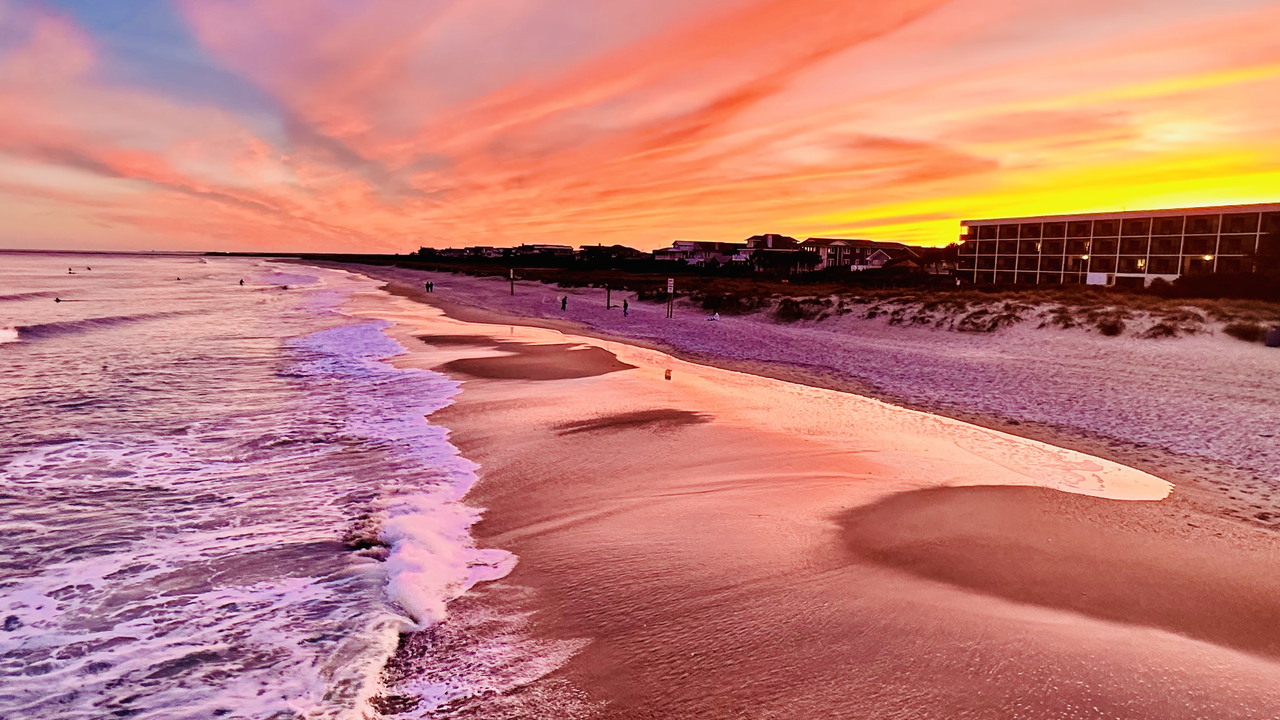 Wrightsville Beach at sunset — dramatic peach and purple sky over the Atlantic